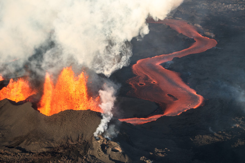 Volcanic eruption: fire-breathing volcano and flowing lava